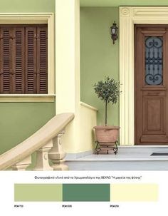 the front door is painted green and has brown shutters on it, along with a white stair case