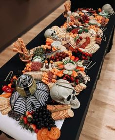 a long table covered in halloween food and decorations