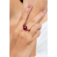 This is part of Chairish’s Fine Jewelry assortment.  Oval Cut Ruby Cocktail ring in 18K Gold which perfectly goes with your personality and also helps you to improve your energy and sensuality. Designed with big oval cut ruby in center and halo of clustered diamonds both side that makes it a perfect fit to wear it on your wedding or style it with any of your basic outfit to give it a glam.  PRODUCT DETAILS :-  > Material - 18K Solid Yellow Gold > Gemstone - Ruby > Gemstone Weight - 2.92 ct > Gemstone pcs - 1  > Gemstone shape - Oval  > Gemstone size - 12 x 9 mm > Diamond weight - 0.25 ct > Diamond Size - 1.5 mm > Diamond pcs - 14  > Gross Weight - 5.494 Grm > Shank width - 2 mm > Setting - Pinion Bezel setting Luxury Oval Ruby Diamond Ring, Gia Certified Oval Ruby Ring, Luxury Ruby Ring With Oval Center Stone, Luxury Oval Ruby Ring With Center Stone, Luxury Oval Ruby Ring With Polished Finish, Luxury Oval Ruby Ring With Prong Setting, Luxury Oval Diamond Ring With Lab-created Ruby, Luxury Oval Ruby Ring With Gemstone, Oval Cabochon Ruby And Diamond Ring