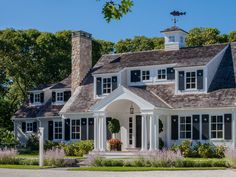 a large white house with black shutters and windows