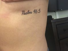 a woman's stomach with the word, psalm 46 5 tattooed on her side