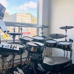 a drum set sitting in front of a window