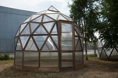 two glass domes sitting in the middle of a field