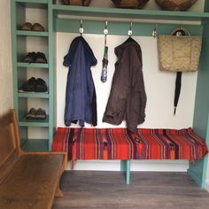 a bench and coat rack in a room