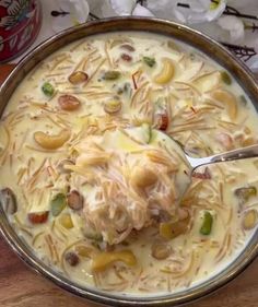 a bowl filled with soup sitting on top of a wooden table