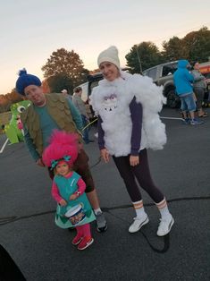 two adults and a child dressed up in costumes