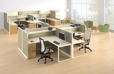 an office cubicle with desks and chairs