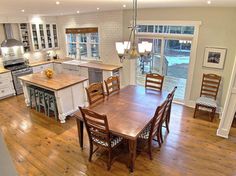 an open kitchen and dining room with hardwood floors