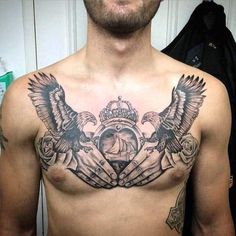 a man with tattoos on his chest has an eagle and clock tattoo on it's chest