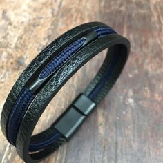 Absolutely beautiful multi strand men's leather bracelet with blue paracord detail. Unparalleled quality and value. Adjustable Blue Leather Bracelets, Adjustable Blue Leather Strap Bracelets, Blue Leather Bracelet As A Gift, Modern Blue Leather Bracelet Gift, Modern Blue Leather Bracelet, Bracelet For Him, Genuine Leather Bracelet, Mens Leather Bracelet, Braided Bracelets