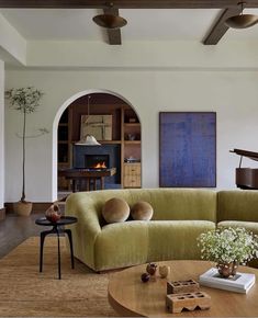 a living room filled with furniture and a piano