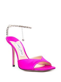 Elevate your style with these stunning Fuchsia Rhinestone Sandals, designed to make you feel glamorous and chic. The eye-catching rhinestone ankle strap adds a touch of sophistication and sparkle to every step you take, making you stand out from the crowd. Made with luxurious materials for ultimate comfort and durability, these sandals are a must-have addition to your designer shoe collection. Bold Fuchsia Pink hue for a pop of color Rhinestone ankle strap for added glamour Constructed with luxu Jimmy Choo Saeda, Jimmy Choo Sandals, Chic Sandals, Rhinestone Sandals, Satin Heels, Moon Boots, Crossbody Tote Bag, Sandals Brands, Fuchsia Pink