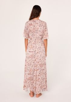 A flowy short flutter sleeve maxi dress in a pink floral print. Floral print Relaxed fit Short flutter sleeves Maxi length Asymmetric hemline V-neckline Elastic waist Self-tie waist belt Lined Bohemian maxi dress Feminine florals add a pretty touch to this classic boho maxi dress. With short flutter sleeves, a flattering v-neckline, and a waist-defining tie belt. The unique asymmetric hemline adds a sweeping touch to the long flowy skirt. Model is 5'9, wearing a size S.Style: I-73347WL-SKF-CG Flowy Belted V-neck Maxi Dress, Flowy V-neck Belted Maxi Dress, Flowy Belted Maxi Dress With V-neck, Pink Flowy Midi Dress With Surplice Neckline, Pink Belted Short Sleeve Dress, Feminine Flowy Maxi Dress With Tie Waist, Flowy Feminine Maxi Dress With Tie Waist, Feminine Maxi Dress With Tie Waist, Feminine Flowy Dress With Tie Waist