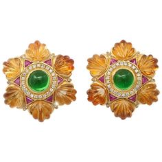 We offer this rich color combination of gem stones in 18K gold ear clips set with large green tourmaline cabochons surrounded by diamonds and triangular cut rubies trimmed with carved shell forms of golden citrine. A post is present but easily removed for a non-pierced ear. Measuring 1 1/2 inches diameter. Weighing 35.6 grams. Dress Earrings, Jewellery Board, Lotus Jewelry, Crazy Stuff, Ear Clips, Costume Earrings, Jewelry Simple, Sell Gold, Diamond Gold