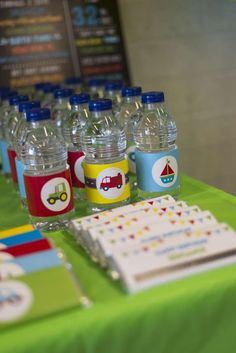 water bottles are lined up on a table with cards and stationery for children's birthdays