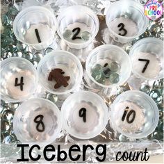 an iceberg counting game is shown with plastic cups filled with coins and numbers on them