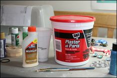 the paint is being used to make this diy project with plastic bottles and other crafting supplies