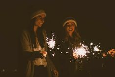 two women are holding sparklers in their hands