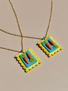 two necklaces that have carrots on them