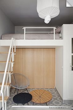 there is a loft bed in the middle of this room with stairs leading up to it