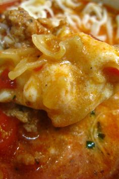 a close up of a plate of food with meat, noodles and sauce on it