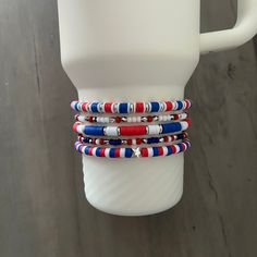 A fun collection of red, white, and blue beaded bracelets hand crafted to add personal style to your Stanley cup.  🌟 Great for gift giving, holidays, sports, parties, and everyday charm. 🌟 Set includes 5 bracelets designed to fit the 40oz Stanley Quencher with a silicone boot in place.  🌟 Variations: 3 Bracelet Stack https://tinebirddesigns.etsy.com/listing/1719875918 4 Bracelet Stack https://tinebirddesigns.etsy.com/listing/1734070961 Tips & Care: - Will also fit the 20oz and 30oz Stanley cu Stanley Bracelet, Boot Toppers, Blue Beaded Bracelets, Stanley Quencher, Usa Patriotic, Bracelet Ideas, Stanley Cup, Charm Set, Bracelet Stack