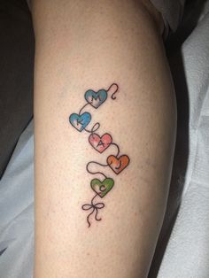 a person with a tattoo on their leg that says love is in the air and hearts are all over them