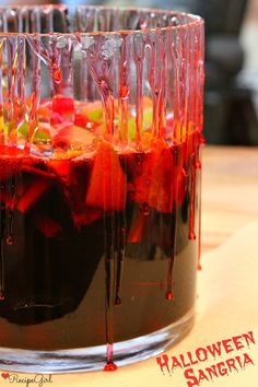 halloween sangria in a glass with red and green jello drizzled on top