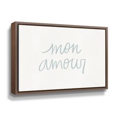 a white and brown framed sign with the words'mon ameur'on it