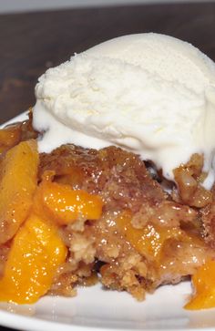 a close up of a plate of food with fruit and ice cream on it's top