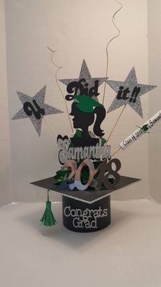 a graduation cake made to look like a graduate's cap with stars and confetti