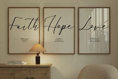 two posters with the words faith hope and love on them in a living room next to a lamp