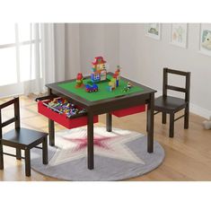 a child's table and chairs set up in a playroom with toys on the floor