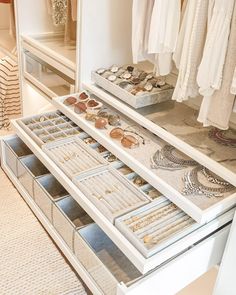 an organized closet with necklaces and jewelry