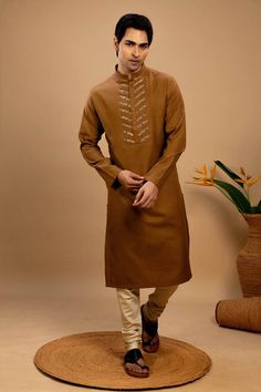 Beige straight kurta with printed panels on the placket. Paired with a straight churidar. - Aza Fashions Unstitched Brown Straight Kurta, Brown Unstitched Straight Kurta, Unstitched Brown Cotton Traditional Wear, Brown Cotton Kurta With Dabka, Brown Straight Kurta For Diwali, Brown Straight Kurta For Eid, Fitted Brown Kurta For Diwali, Cotton Bandhgala With Cutdana In Straight Kurta Style, Traditional Brown Cotton Kurta