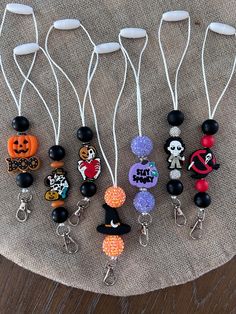 several halloween themed items are displayed on a cloth covered table with white string and black beads