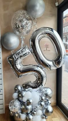 silver balloons are arranged in the shape of numbers