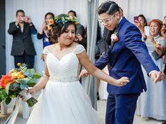 a bride and groom walking down the aisle