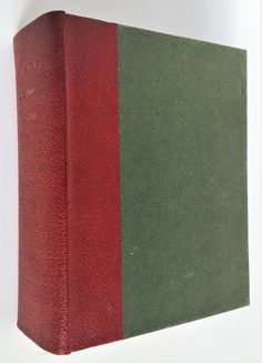 a red and green book sitting on top of a white table