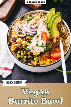 a bowl filled with rice, beans and avocado on top of a table