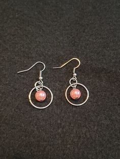 Show your mom that she is special with these pretty in pink faux pearl earrings. This silver looped earrings have a pink pearl dangling in the center. Pink Nickel-free Beaded Drop Earrings, Pink Hypoallergenic Beaded Drop Earrings, Elegant Pink Metal Beaded Earrings, Elegant Pink Beaded Metal Earrings, Nickel-free Pink Dangle Beaded Earrings, Pink Hypoallergenic Beaded Dangle Earrings, Hypoallergenic Pink Beaded Dangle Earrings, Elegant Pink Beaded Hypoallergenic Earrings, Elegant Pink Hypoallergenic Beaded Earrings