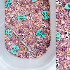 a bath tub filled with pink and purple rice covered in googly eyes, eyeballs, and other decorations