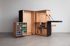 an open wooden cabinet with drawers and shelves