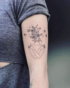 a woman's arm with a flower tattoo on the left side of her body