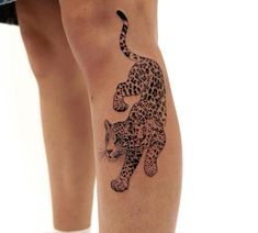 a woman's leg with a tattoo of a leopard on it