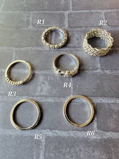 four different types of rings on a stone floor