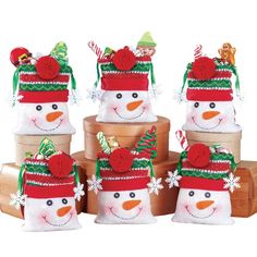 several snowmen wearing hats and scarves are stacked on top of each other