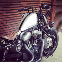 a motorcycle parked next to a wooden wall