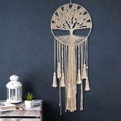 a wooden wind chime hanging on the wall next to a table with a lamp