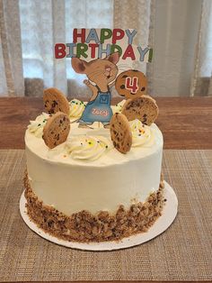 a birthday cake decorated with cookies and frosting